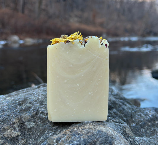 Handmade patchouli and ylang ylang soap bar infused with mixed dried flowers and scented with patchouli, ylang ylang, and lemon essential oils. Made with organic coconut oil, olive oil, mango seed butter, and shea butter for a nourishing and aromatic cleanse. Each bar weighs approximately 3 ounces and is wrapped in eco-friendly lokta paper.